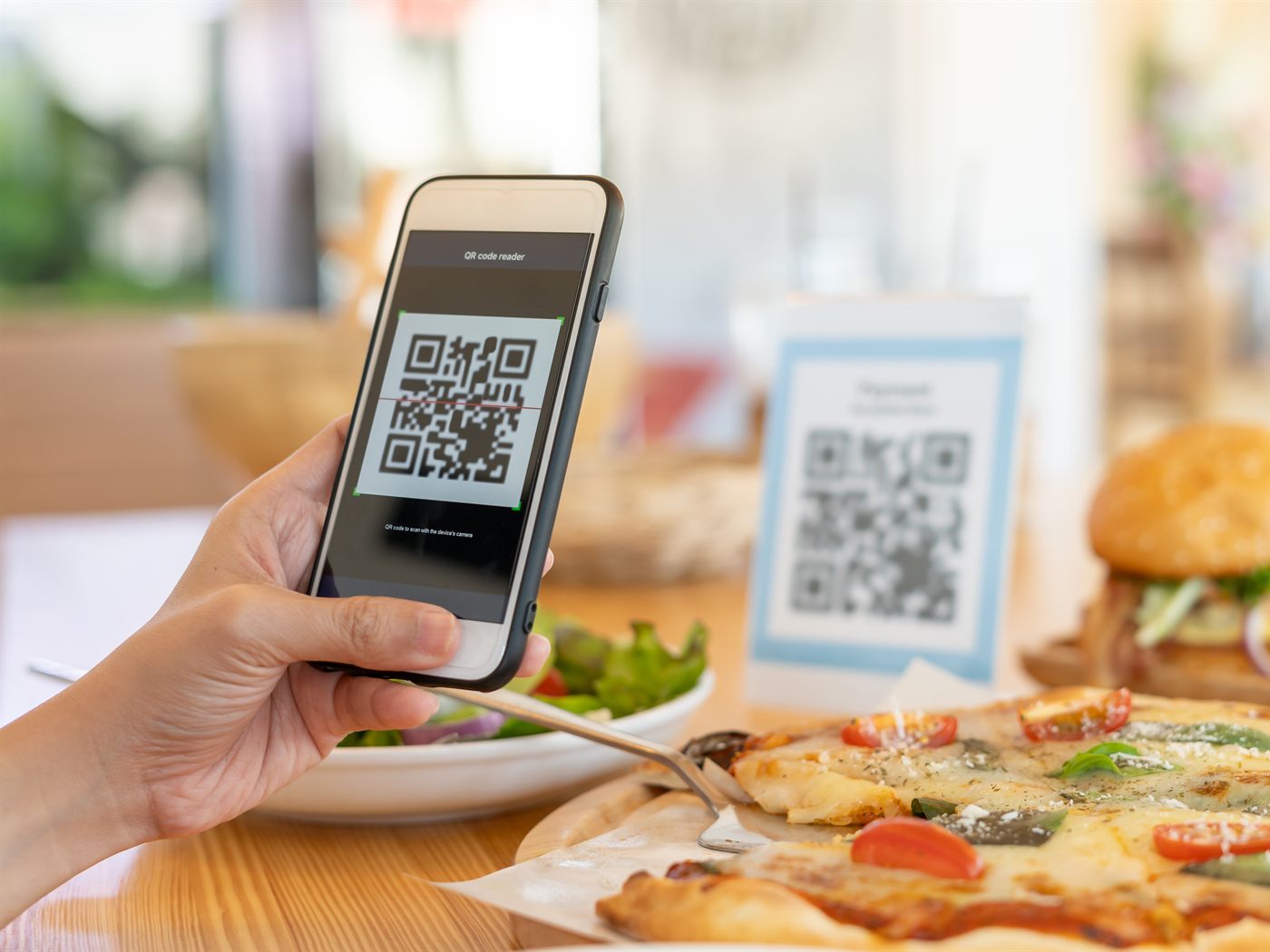 Πελάτης σκανάρει QR code στο τραπέζι εστιατορίου για να δει το μενού